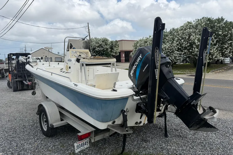 Slide: The Image of 2006 NAUTIC STAR 2100 boat with Mercury engine on trailer, parked outdoors. - 5