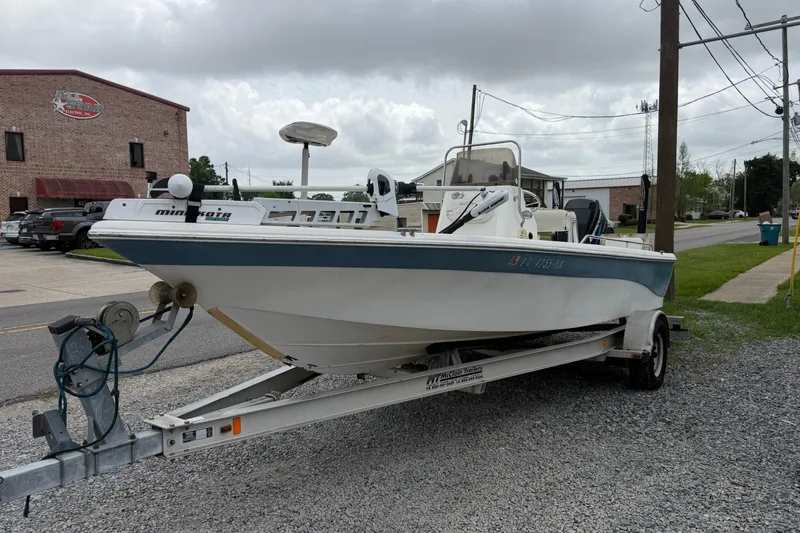 Slide: The Image of 2006 NAUTIC STAR 2100 boat on trailer, parked outdoors near a brick building. - 6