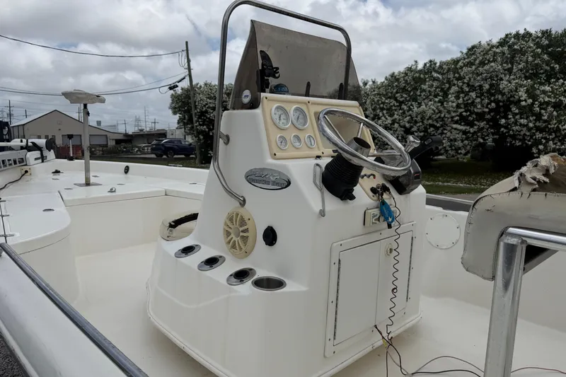 Slide: The Image of 2006 NAUTIC STAR 2100 boat console with steering wheel and gauges, outdoors. - 9