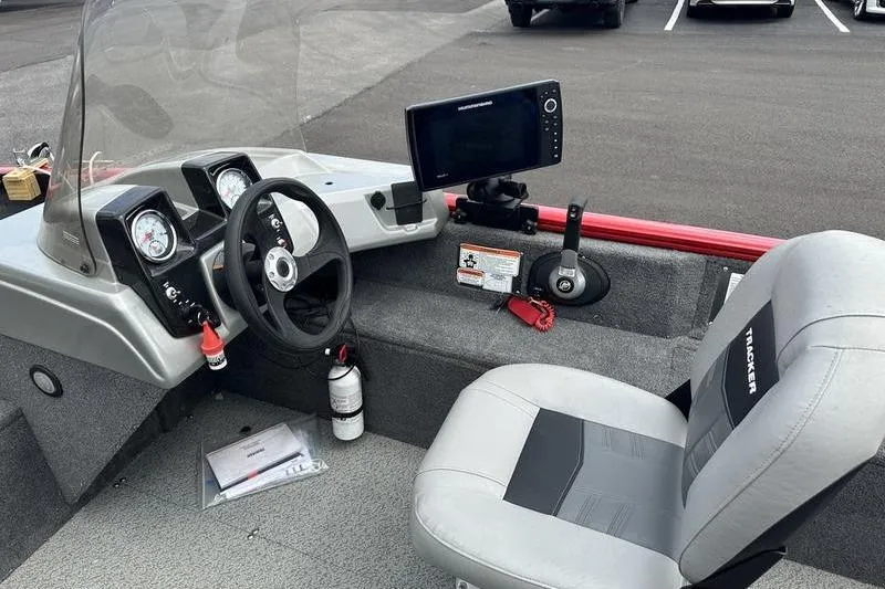 Slide: The Image of 2017 Tracker Pro Guide V-16 SC boat interior with steering wheel, gauges, and navigation screen. - 11