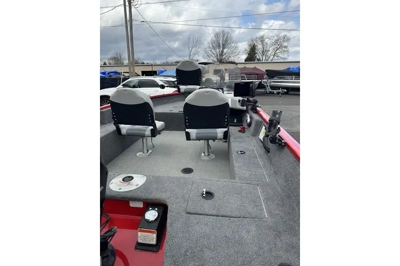 Slide: The Image of 2017 Tracker Pro Guide V-16 SC boat interior with seating and equipment. - 2
