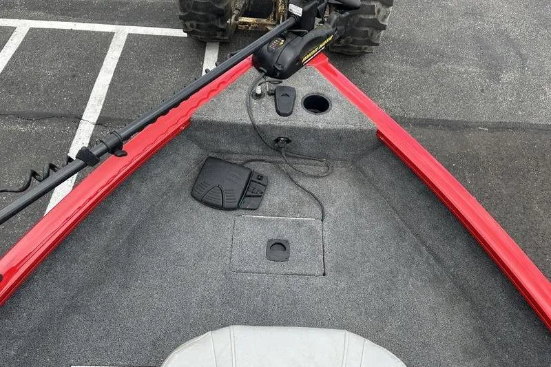 Slide: The Image of 2017 Tracker Pro Guide V-16 SC boat interior with red trim and fishing equipment. - 3