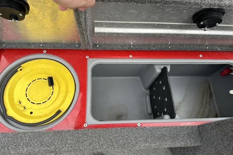 Slide: The Image of 2017 Tracker Pro Guide V-16 SC boat storage compartments with yellow lid and open hatch. - 7