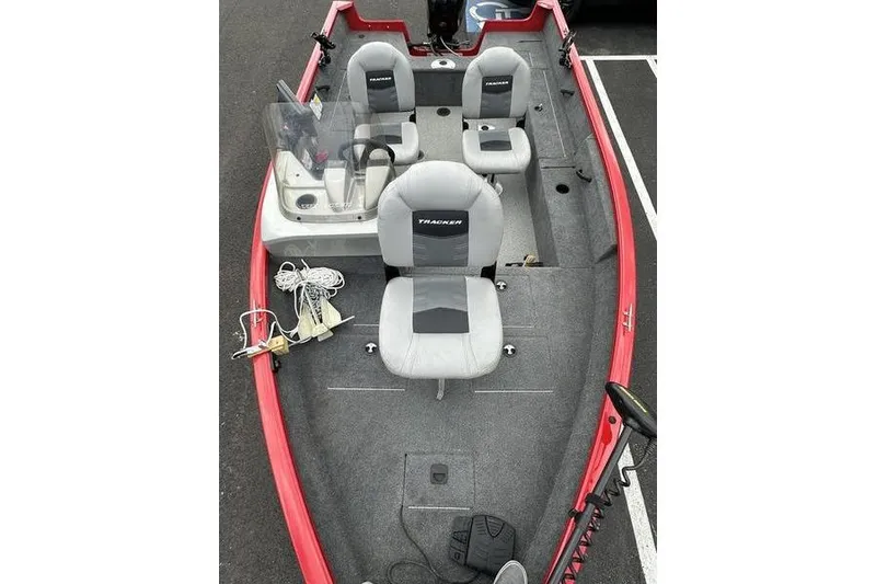 Slide: The Image of 2017 Tracker Pro Guide V-16 SC fishing boat with gray seating and red exterior. - 8