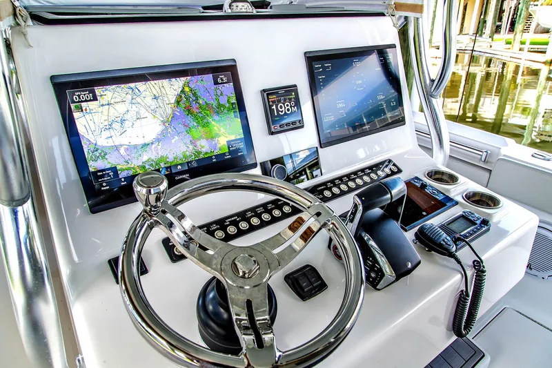 Slide: The Image of Front Runner 33 Center Console 2023 helm with navigation systems. - 18