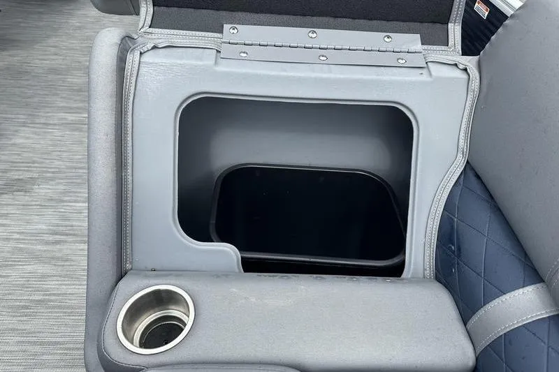 Slide: The Image of Bennington L 23 L-Bench 2022 storage compartment with cup holder, open lid view. - 3