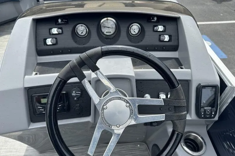 Slide: The Image of 2022 Bennington L 23 L-Bench boat dashboard with steering wheel and gauges. - 4