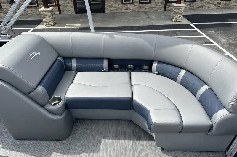 Slide: The Image of Luxurious seating on 2022 Bennington L 23 L-Bench pontoon boat, featuring cup holders and stylish design. - 5