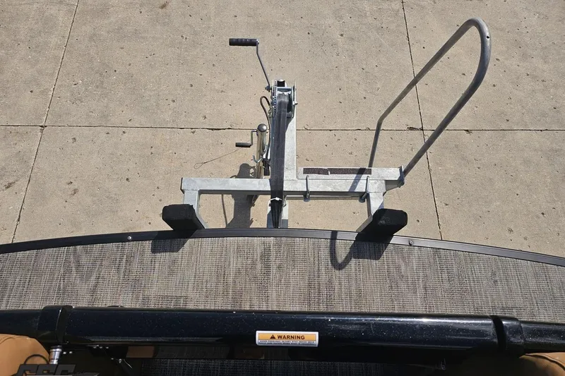 Slide: The Image of 2024 Avalon Excalibur Quad Lounge boat trailer hitch and winch system. - 100