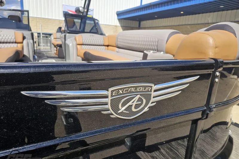 Slide: The Image of 2024 Avalon Excalibur Quad Lounge Windshield boat with luxurious seating and sleek design. - 19