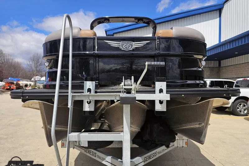 Slide: The Image of 2024 Avalon Excalibur Quad Lounge Windshield boat on trailer, outdoor setting. - 21