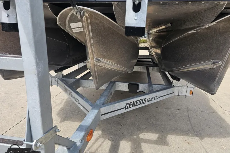 Slide: The Image of 2024 Avalon Excalibur Quad Lounge on Genesis trailer, showcasing pontoon undercarriage. - 22