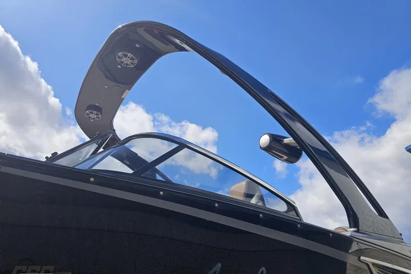 Slide: The Image of 2024 Avalon Excalibur Quad Lounge boat with sleek windshield against blue sky. - 28