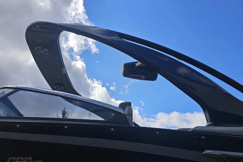 Slide: The Image of 2024 Avalon Excalibur Quad Lounge boat with sleek windshield against blue sky. - 29