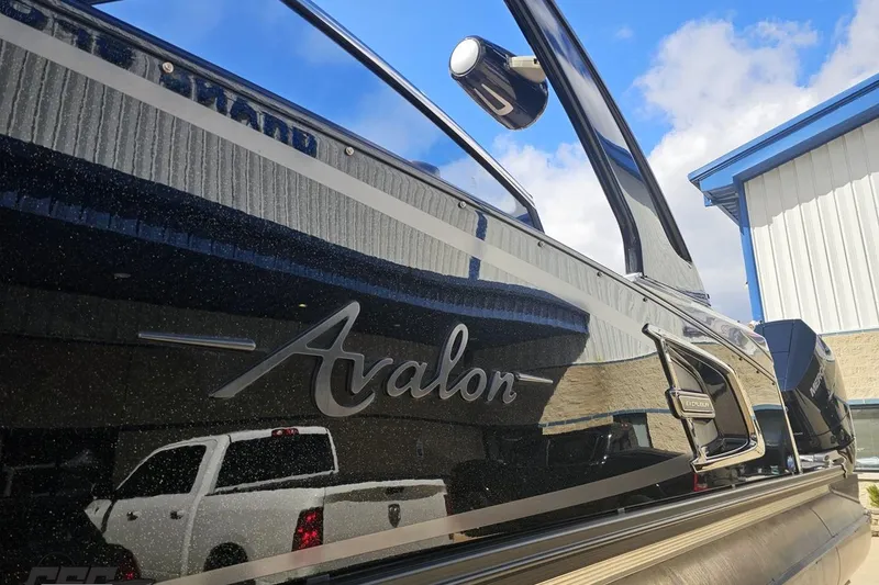 Slide: The Image of 2024 Avalon Excalibur Quad Lounge Windshield boat with sleek design and reflective surface. - 30