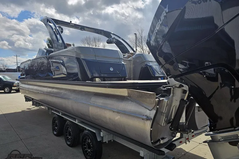 Slide: The Image of 2024 Avalon Excalibur Quad Lounge Windshield boat on trailer, featuring sleek design and powerful engine. - 36