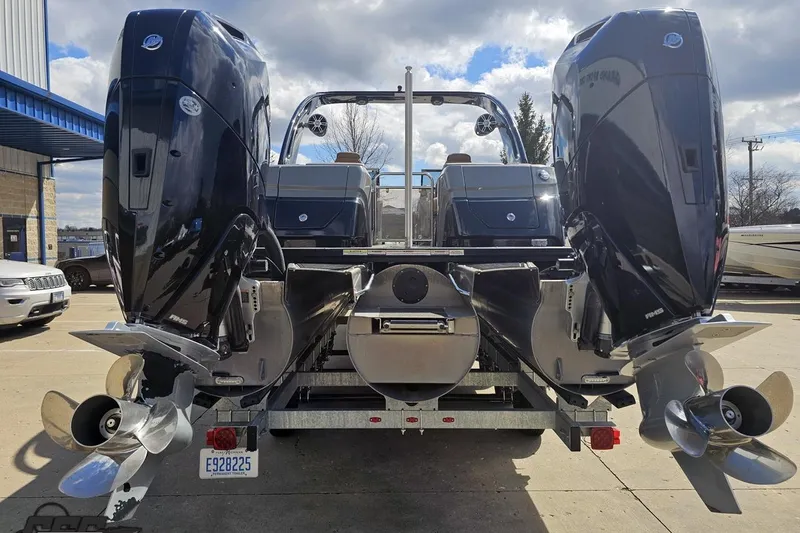 Slide: The Image of 2024 Avalon Excalibur Quad Lounge Windshield boat with dual outboard motors, rear view. - 38