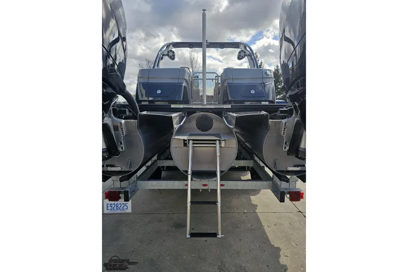 Slide: The Image of 2024 Avalon Excalibur Quad Lounge boat rear view with ladder and dual engines. - 39
