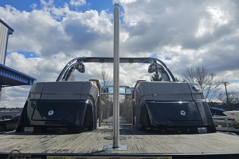 Slide: The Image of 2024 Avalon Excalibur Quad Lounge Windshield boat under a partly cloudy sky. - 40