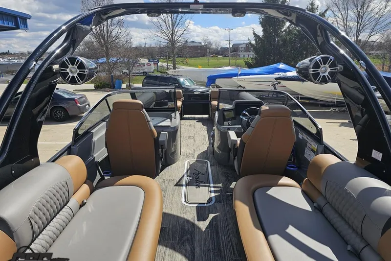 Slide: The Image of 2024 Avalon Excalibur Quad Lounge Windshield boat interior with luxurious seating and modern design. - 53
