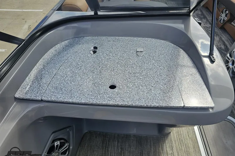 Slide: The Image of 2024 Avalon Excalibur Quad Lounge Windshield boat with sleek granite-style surface detail. - 74