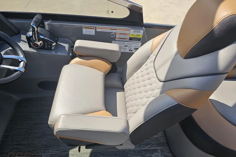 Slide: The Image of Luxurious captain's chair in 2024 Avalon Excalibur Quad Lounge Windshield boat, featuring premium upholstery. - 76