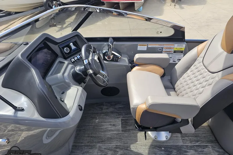 Slide: The Image of 2024 Avalon Excalibur Quad Lounge Windshield boat interior with modern helm and luxurious seating. - 77