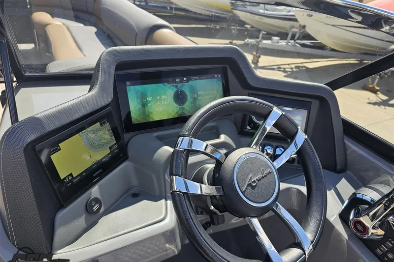 Slide: The Image of 2024 Avalon Excalibur Quad Lounge dashboard with modern controls and sleek steering wheel design. - 80