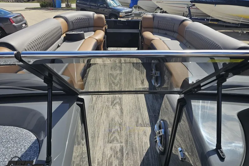 Slide: The Image of 2024 Avalon Excalibur Quad Lounge Windshield boat interior with luxurious seating and modern design. - 86