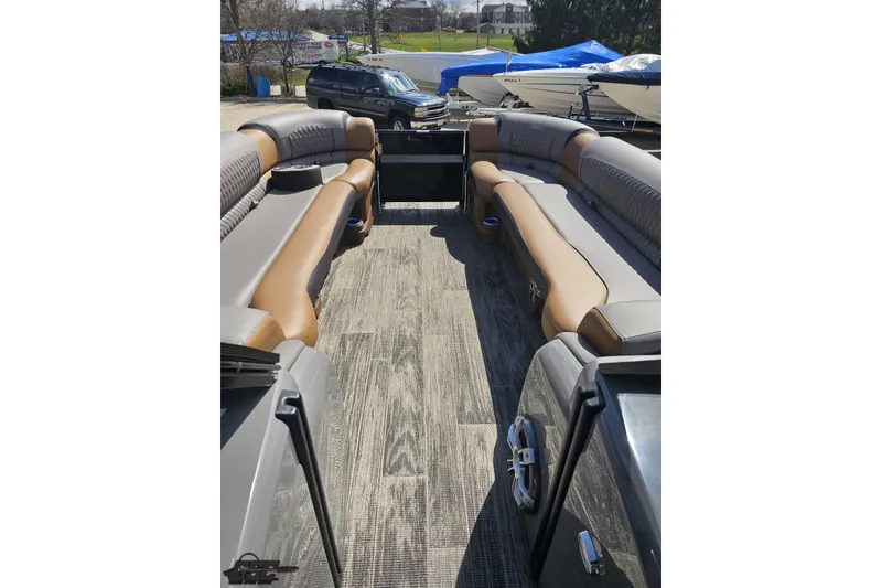 Slide: The Image of 2024 Avalon Excalibur Quad Lounge Windshield boat interior with luxurious seating and wood-style flooring. - 88