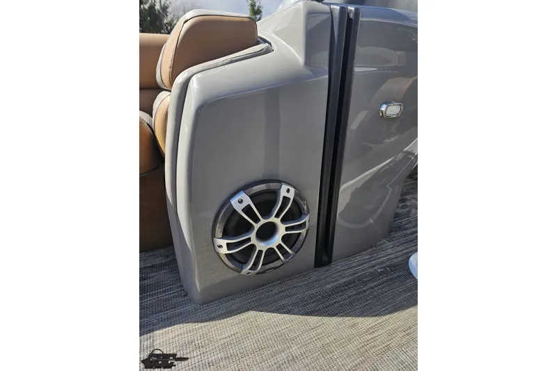 Slide: The Image of 2024 Avalon Excalibur Quad Lounge Windshield boat speaker detail, featuring sleek gray panel design. - 90
