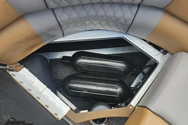 Slide: The Image of 2024 Avalon Excalibur Quad Lounge storage compartment with black fenders and quilted seating. - 93