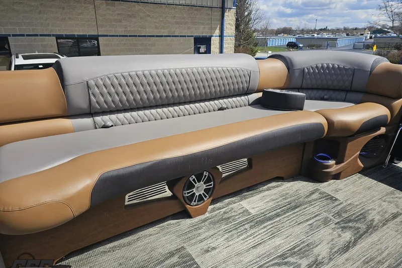 Slide: The Image of Luxurious seating on 2024 Avalon Excalibur Quad Lounge Windshield boat, featuring elegant upholstery and speakers. - 94