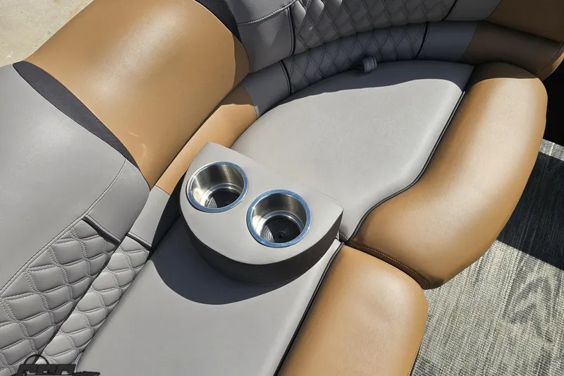 Slide: The Image of 2024 Avalon Excalibur Quad Lounge seating with dual cup holders, featuring luxurious brown and gray upholstery. - 96