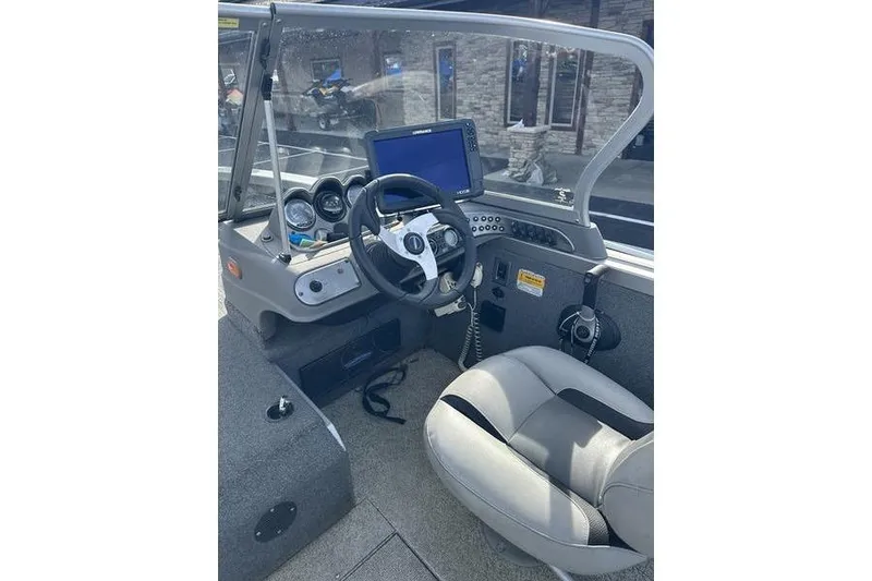 Slide: The Image of 2011 Crestliner 1850 Fish Hawk SC boat cockpit with steering wheel and navigation system. - 11