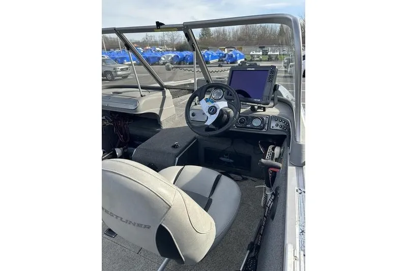 Slide: The Image of 2011 Crestliner 1850 Fish Hawk SC boat interior with steering wheel and navigation system. - 13