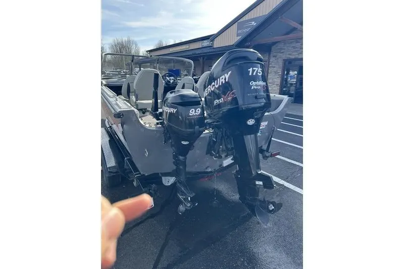 Slide: The Image of 2011 Crestliner 1850 Fish Hawk SC with dual Mercury outboard motors in a parking lot. - 4