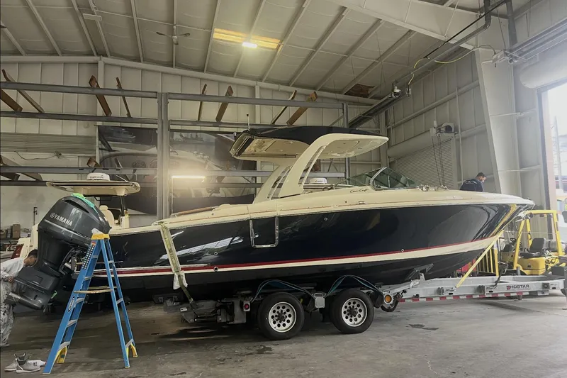 Slide: The Image of 2021 Chris-Craft Launch 31 GT boat in a workshop on a trailer. - 0