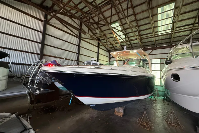 Slide: The Image of 2021 Chris-Craft Launch 31 GT boat in storage, showcasing sleek design and craftsmanship. - 1