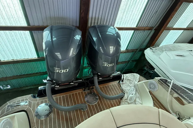 Slide: The Image of 2021 Chris-Craft Launch 31 GT with twin Yamaha 300 engines in a boathouse. - 10
