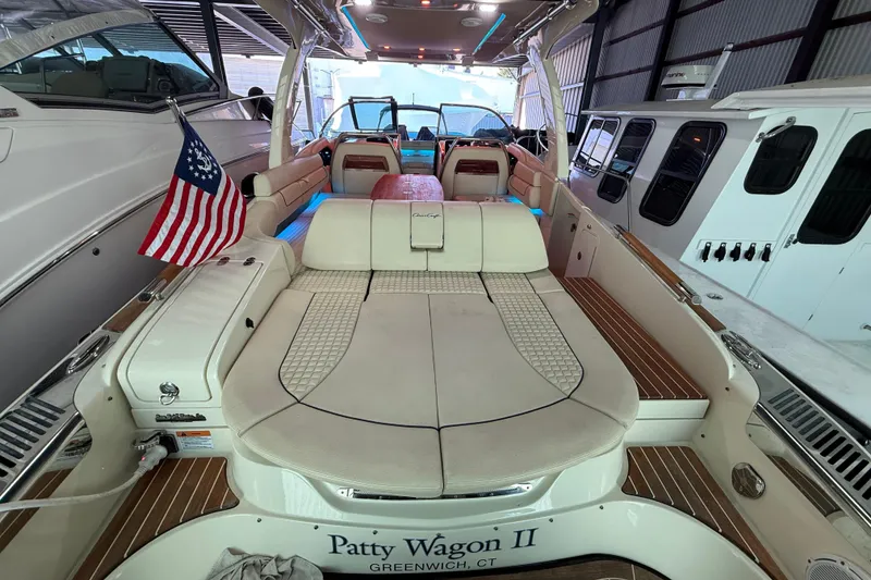 Slide: The Image of 2021 Chris-Craft Launch 31 GT boat interior with American flag, docked in a marina. - 14
