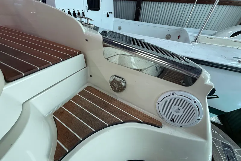Slide: The Image of 2021 Chris-Craft Launch 31 GT boat interior with wood accents and speaker detail. - 15