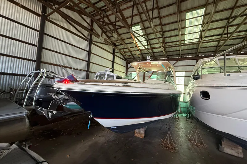 Slide: The Image of 2021 Chris-Craft Launch 31 GT boat in storage, showcasing sleek design and craftsmanship. - 2