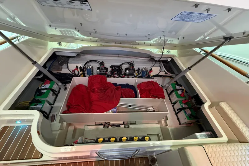 Slide: The Image of Engine compartment of 2021 Chris-Craft Launch 31 GT, showcasing batteries and storage. - 20