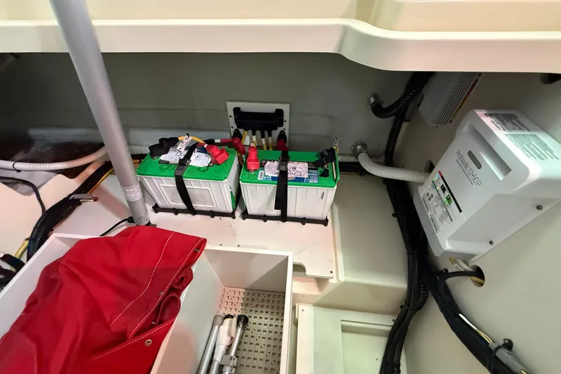 Slide: The Image of 2021 Chris-Craft Launch 31 GT battery compartment with dual batteries and wiring. - 21