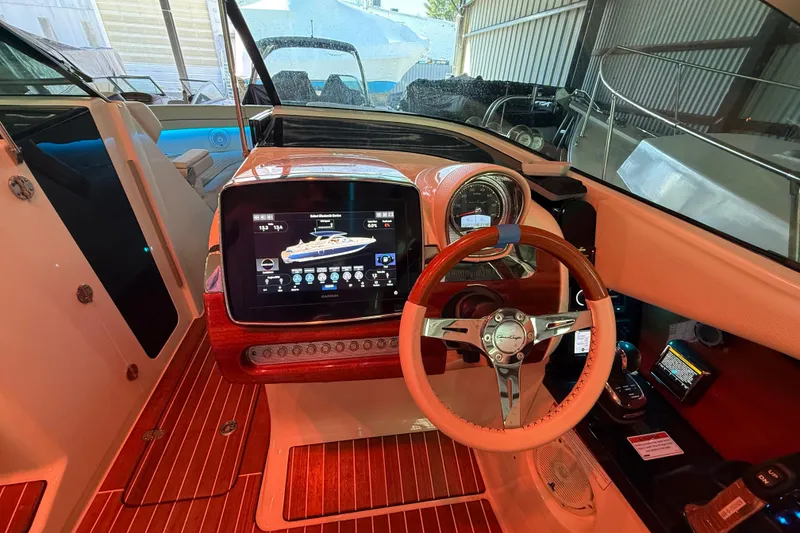 Slide: The Image of 2021 Chris-Craft Launch 31 GT dashboard with modern controls and wooden steering wheel. - 26