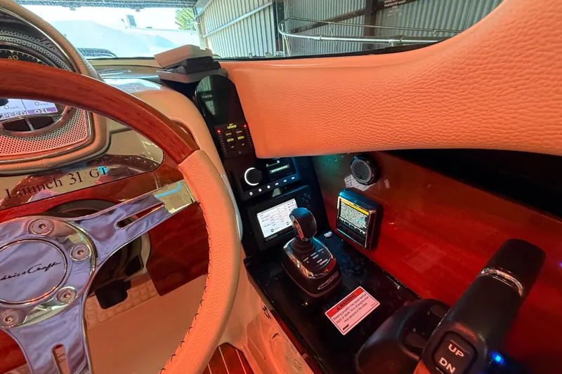 Slide: The Image of 2021 Chris-Craft Launch 31 GT dashboard with steering wheel and control panel. - 27