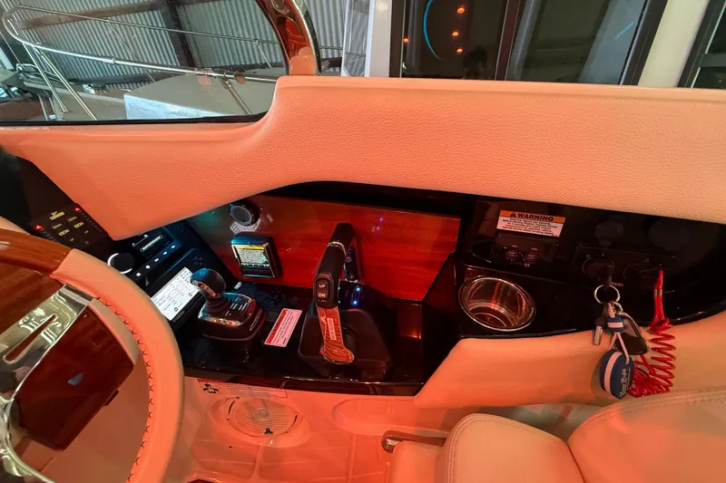Slide: The Image of 2021 Chris-Craft Launch 31 GT helm with controls, steering wheel, and dashboard details. - 28