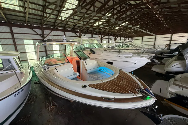 Slide: The Image of 2021 Chris-Craft Launch 31 GT boat in storage, showcasing elegant design and spacious interior. - 3