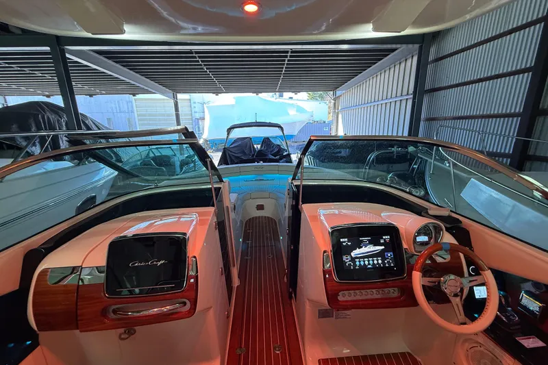Slide: The Image of 2021 Chris-Craft Launch 31 GT boat interior with modern dashboard and steering wheel. - 34